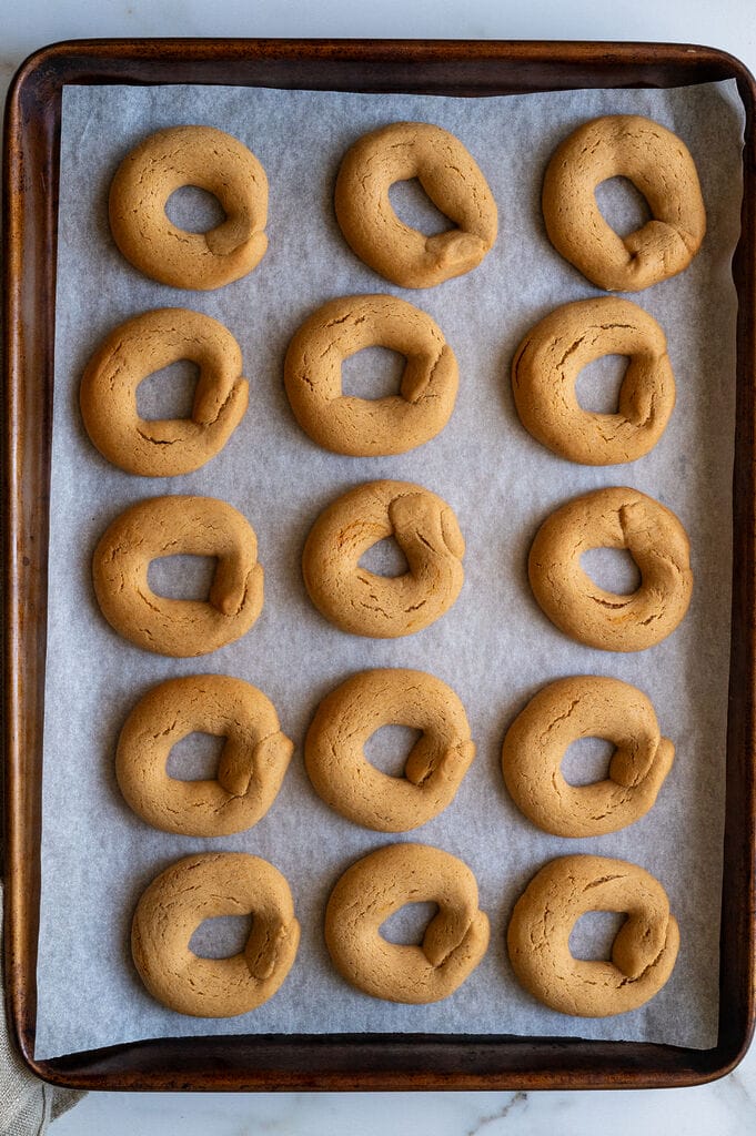 Greek moustokouloura cookies (Grape must cookies with petimezi) on a baking tray.