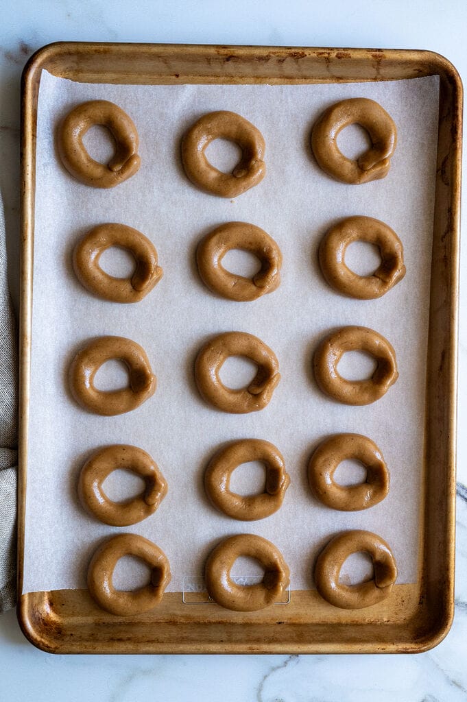Greek moustokouloura cookies (Grape must cookies with petimezi) on a baking tray.