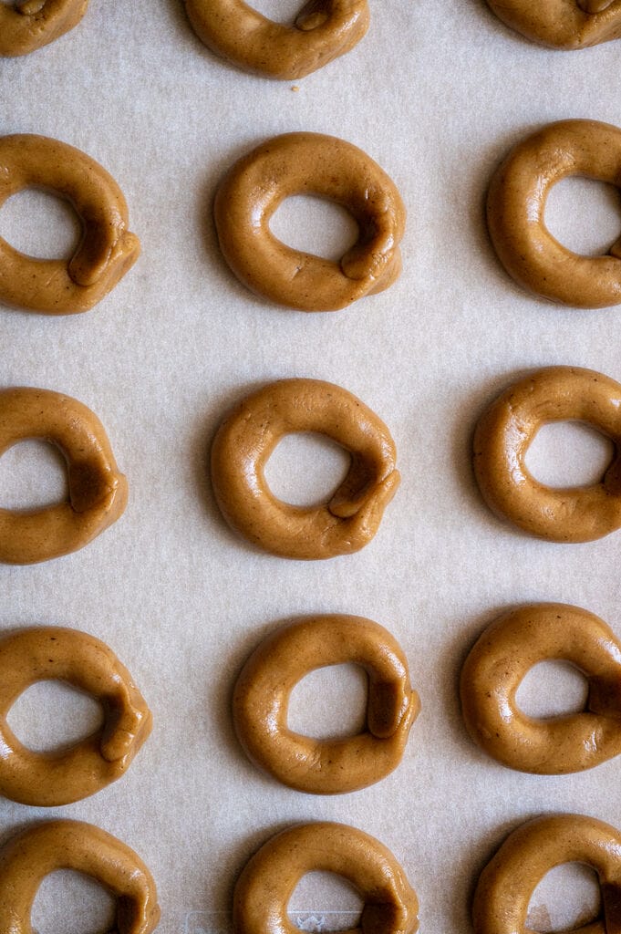 Greek moustokouloura cookies (Grape must cookies with petimezi) on a baking tray.