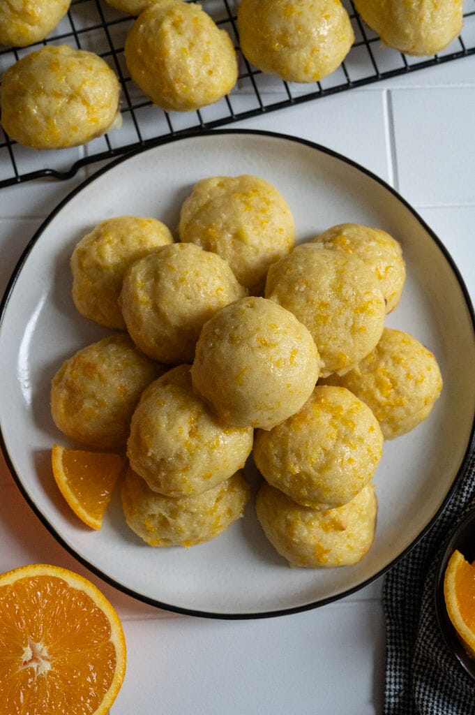 Orange ricotta cookies on a plate.