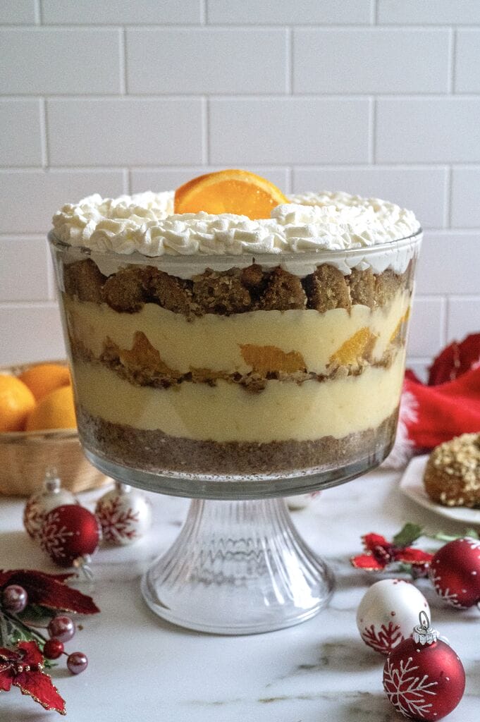 Completed Greek melomakarona trifle in a glass trifle bowl.