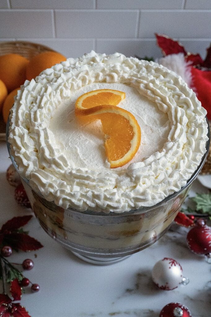 Completed Greek melomakarona trifle in a glass trifle bowl.