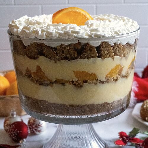 Completed Greek melomakarona trifle in a glass trifle bowl.