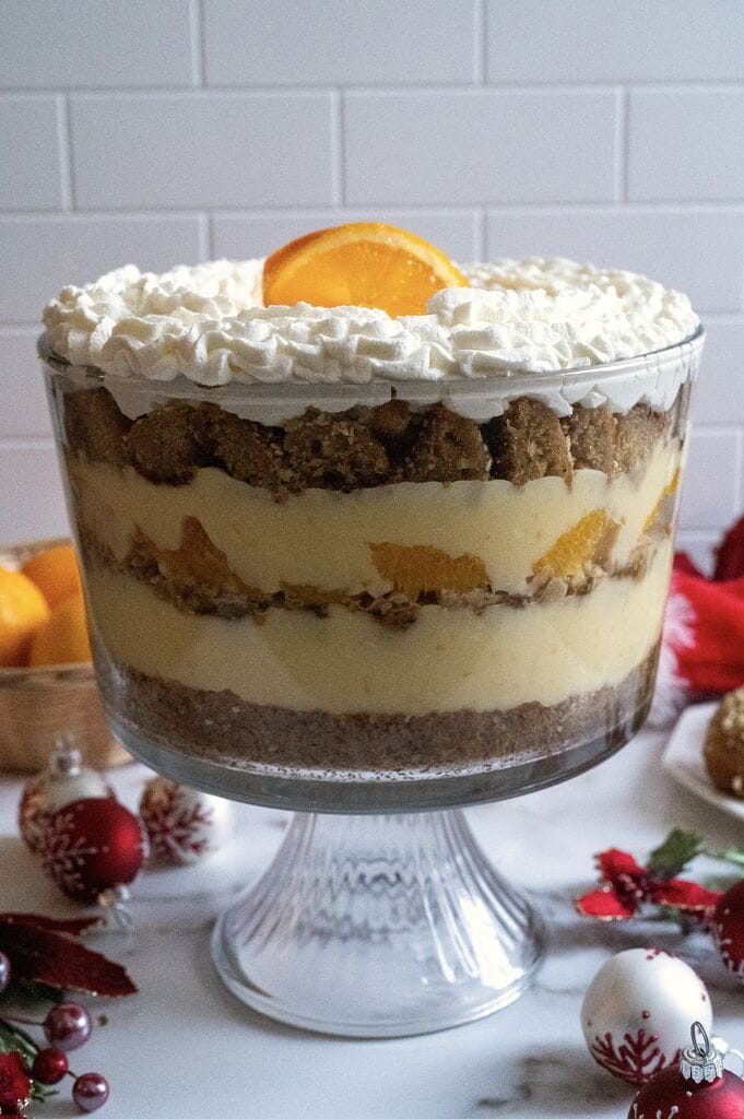 Completed Greek melomakarona trifle in a glass trifle bowl.