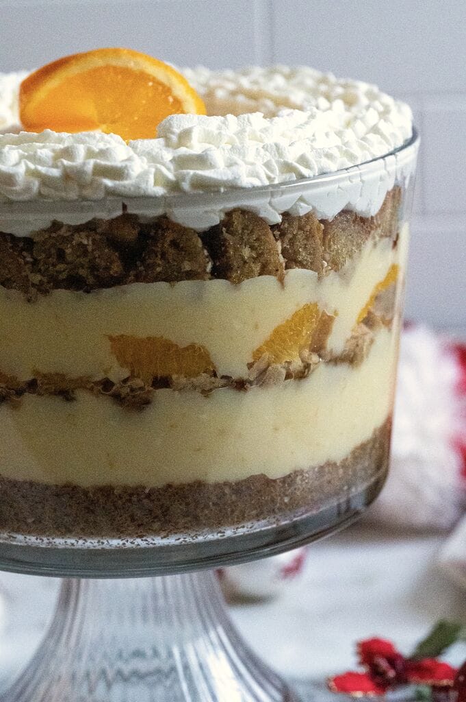 Completed Greek melomakarona trifle in a glass trifle bowl.