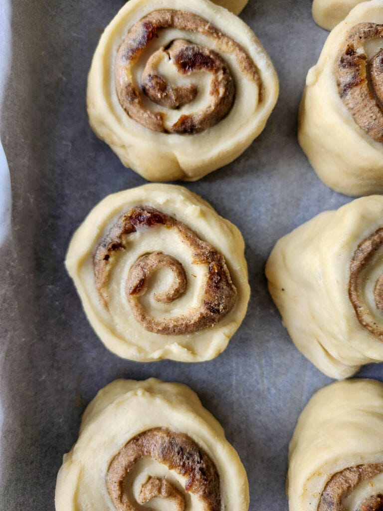 Sticky toffee cinnamon buns with dates ready to bake.