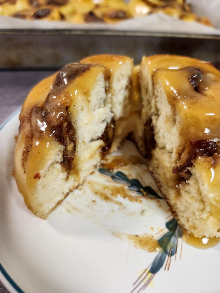 Sticky toffee cinnamon buns with dates baked and ready to enjoy. Here you see what the inside looks like.