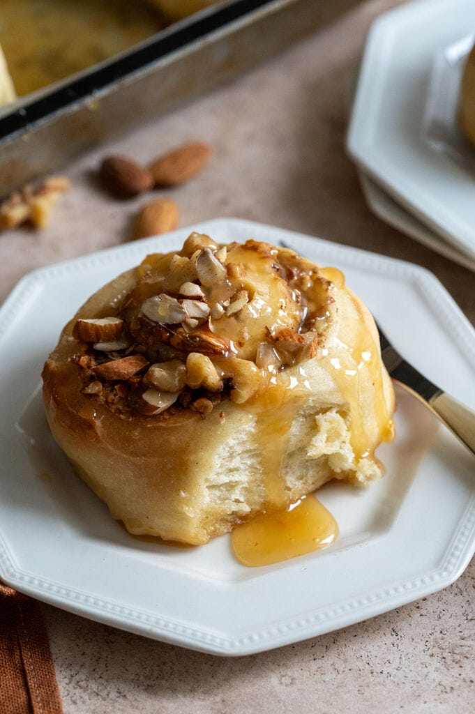 Baklava cinnamon roll on a white plate.