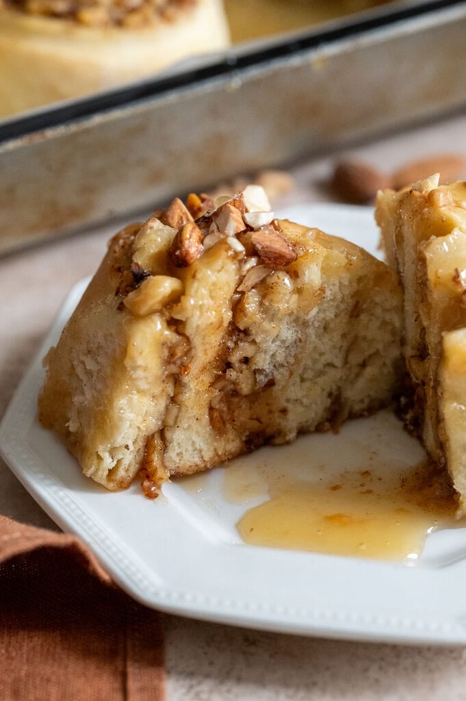 Baklava cinnamon roll on a white plate, cut open.
