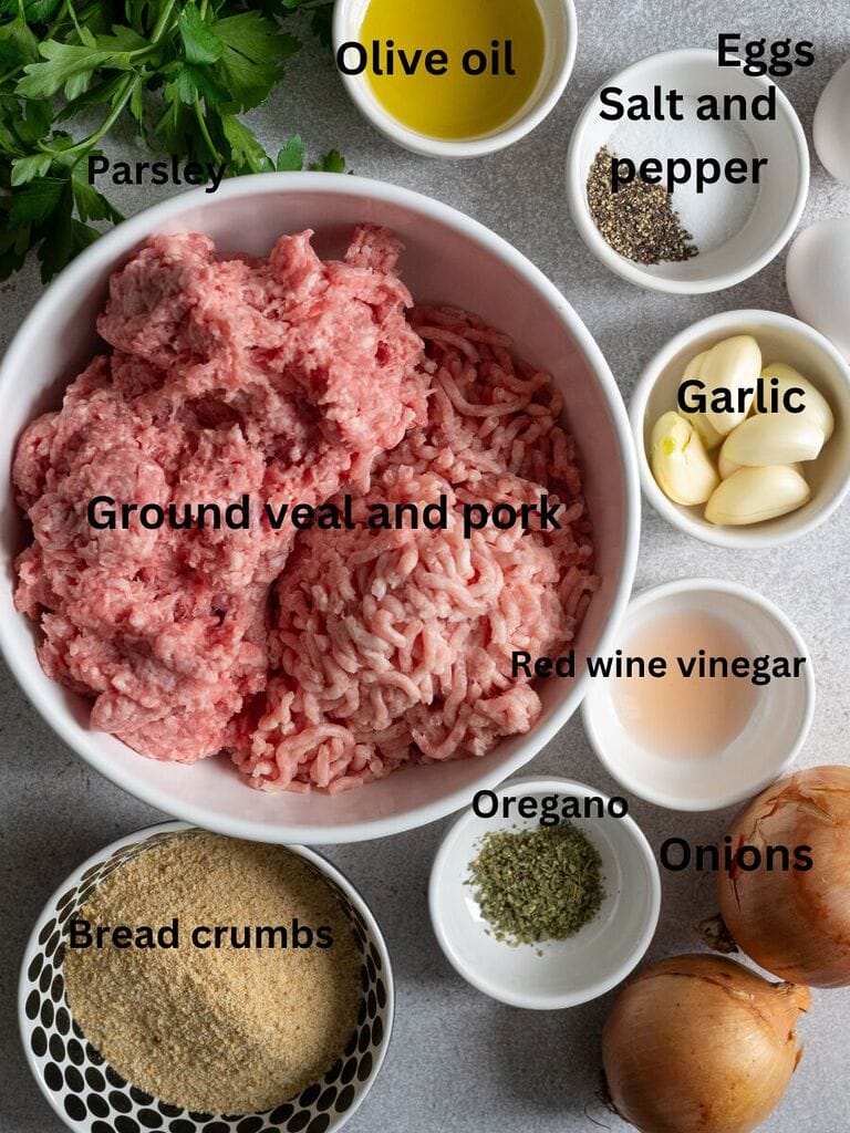 Ingredients for Greek soutzoukakia with rice: parsley, ground meat, olive oil, eggs, salt, pepper, garlic, red wine vinegar, oregano, onions and bread crumbs
