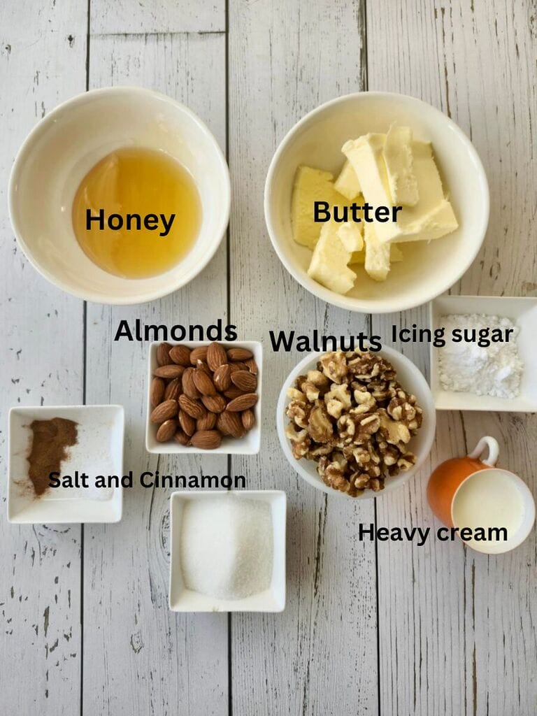 Ingredients for the mixture which include: honey, butter, almonds, walnuts, icing sugar, salt, cinnamon and heavy cream.