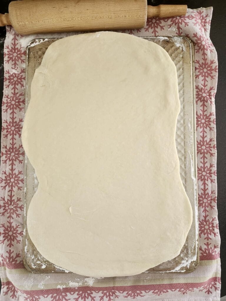 Rolling out the dough into a rectangle shape.