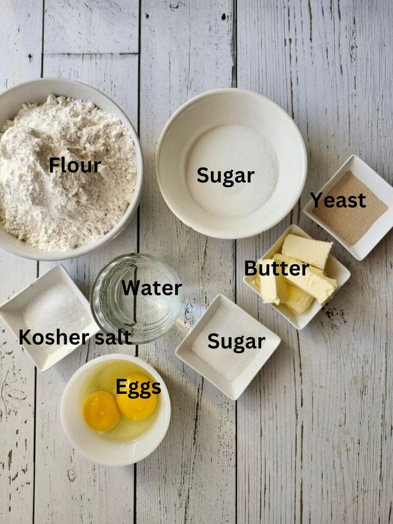 Ingredients for the dough which include: Flour, sugar, salt, water, sugar, butter, yeast and eggs.