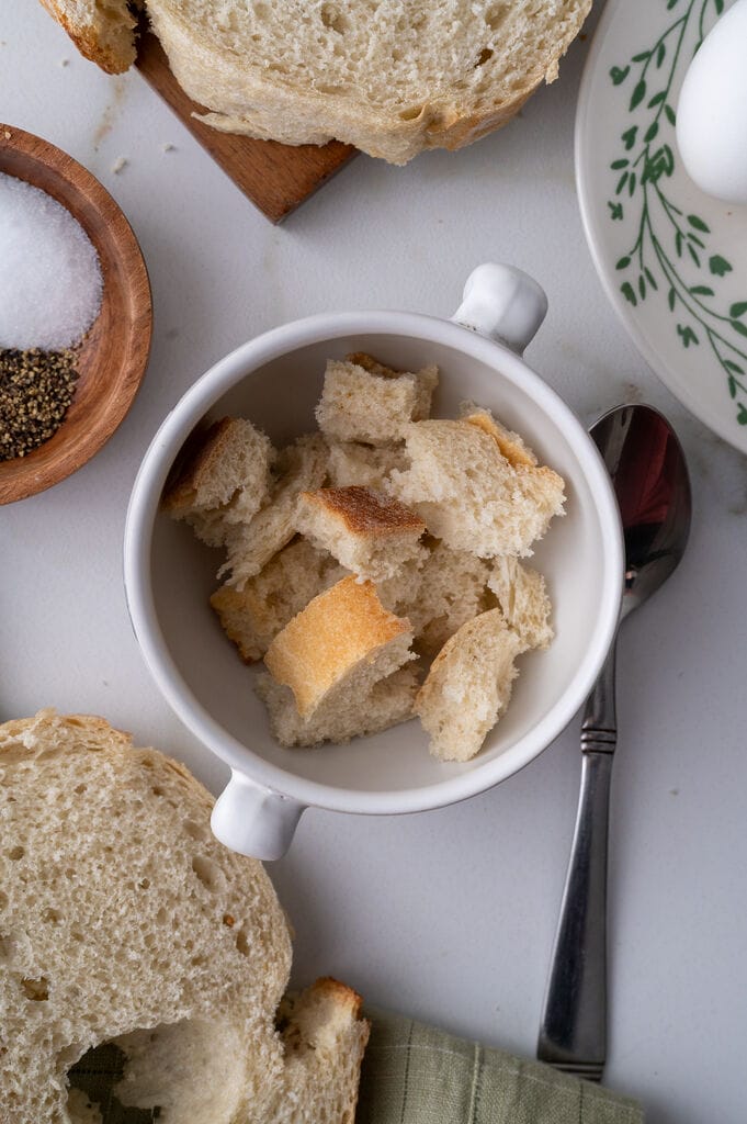Cubes of breads in a white bowl.