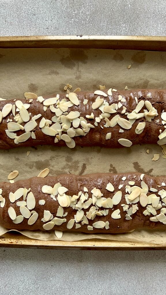Baking the Easy Italian chocolate biscotti on a parchment lined baking sheet pan.
