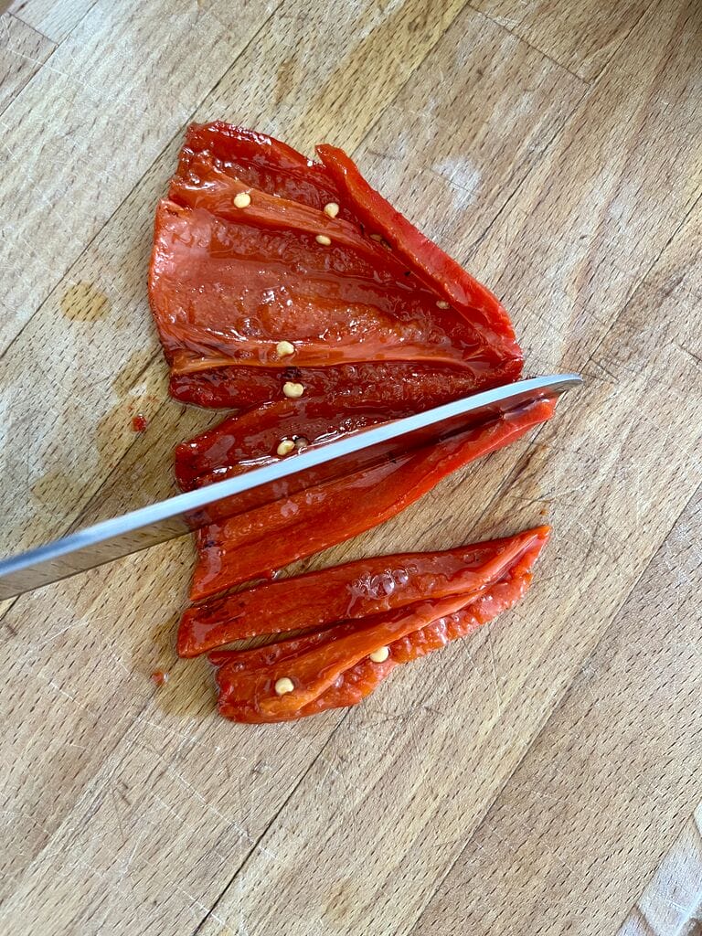 Cutting the red peppers into strips.