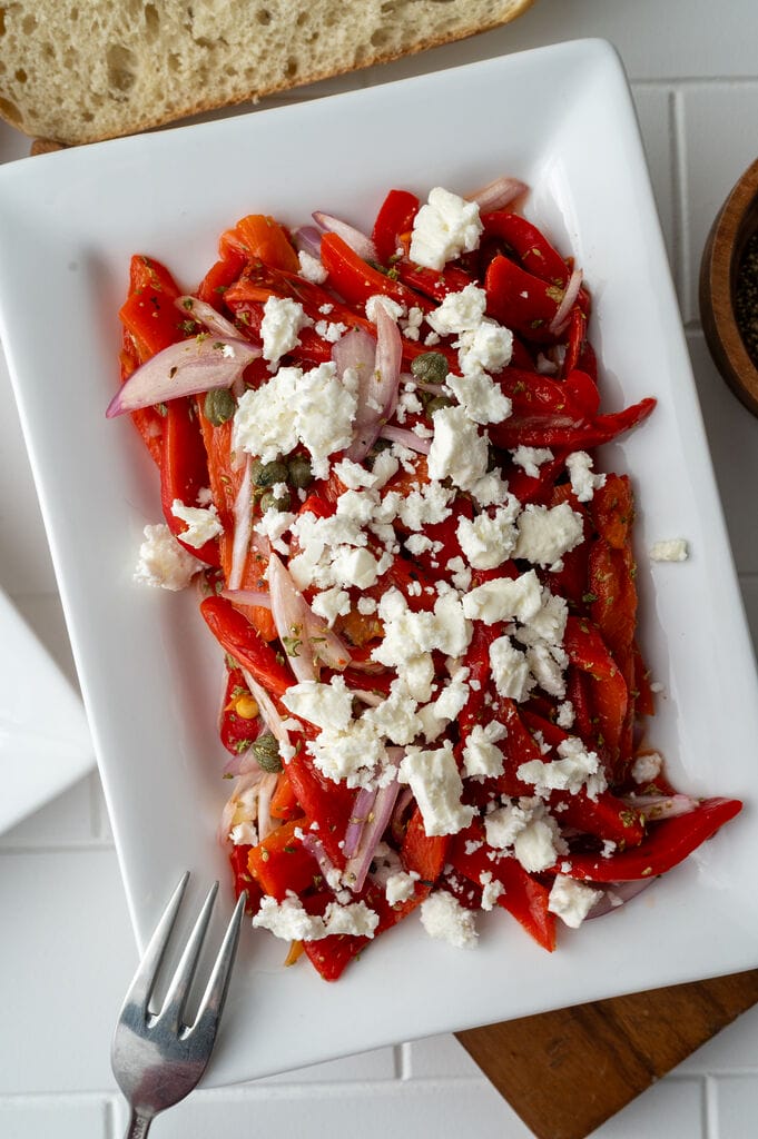 Roasted red pepper and feta salad on a white plate.