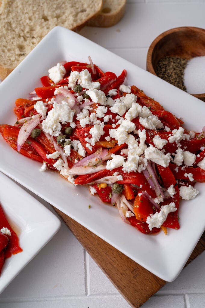 Roasted red pepper and feta salad on a white plate.