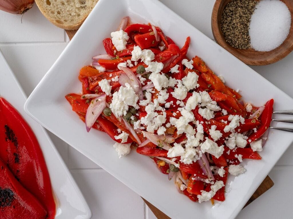 Roasted red pepper and feta salad on a white plate.
