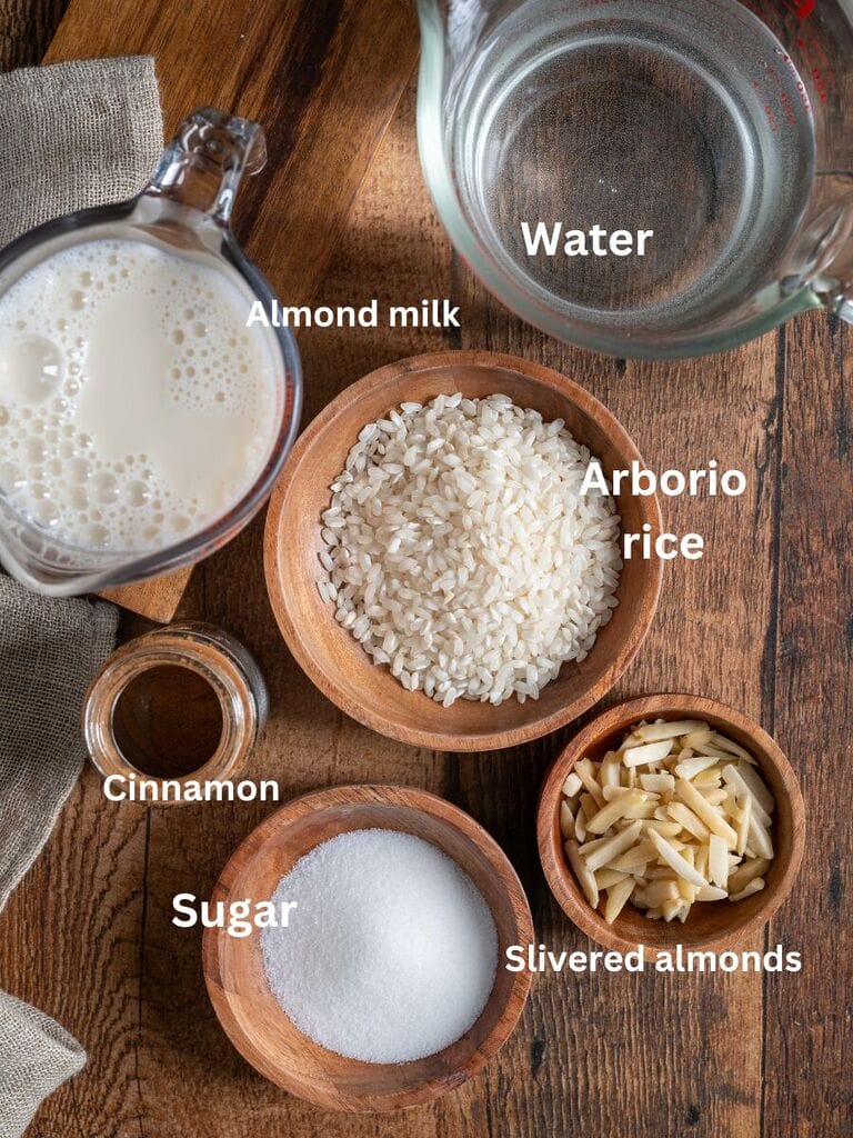 Ingredients for the vegan rice pudding/rizogalo which include: Almond milk, arborio rice, water, sugar, cinnamon and slivered almonds.