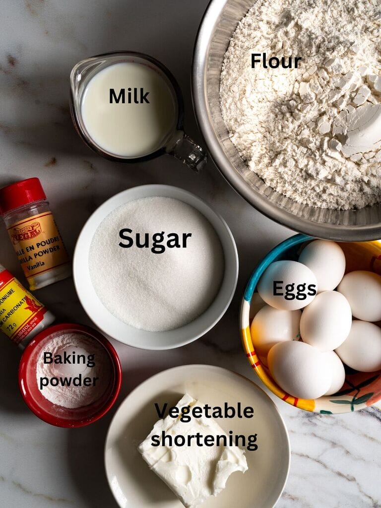 Ingredients for the koulourakia which include Flour, Sugar, Milk, eggs, vegetable shortening, baking powder, powdered vanilla, and ammonium carbonate.