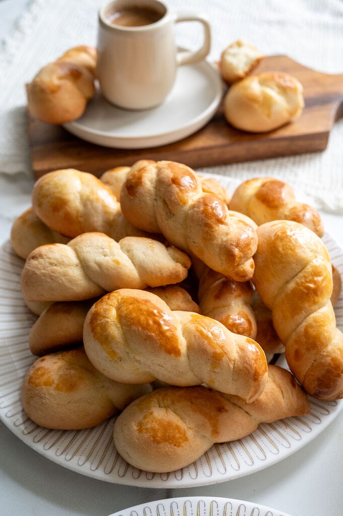 Koulourakia, a Greek cookie. Plated on a white platter with a gold trim.