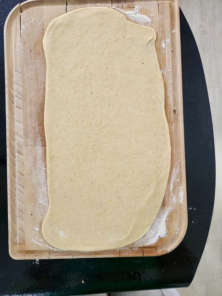 Rolling out the white dough.