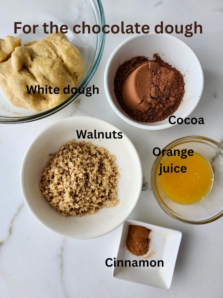 Ingredients to make the chocolate dough, which include the white dough; walnuts; cocoa, orange juice and cinnamon.