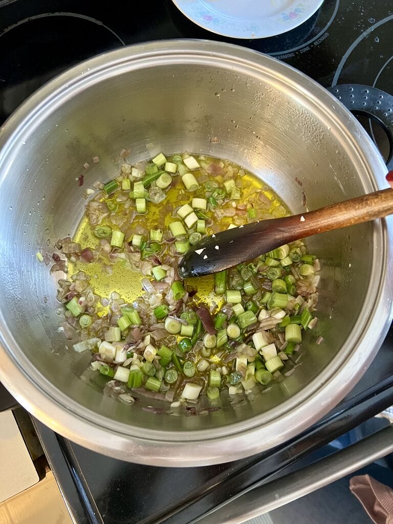 Sautéing the red and green onions.