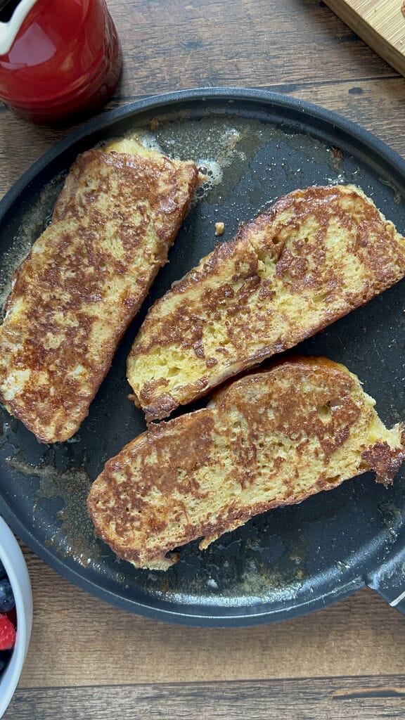 Frying the tsoureki French toast.
