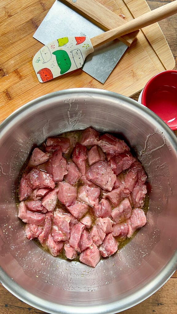 Marinating the pork pieces.