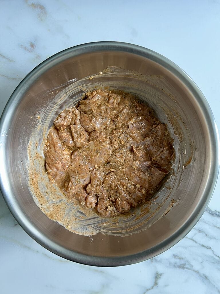 Marinading the chicken thighs.