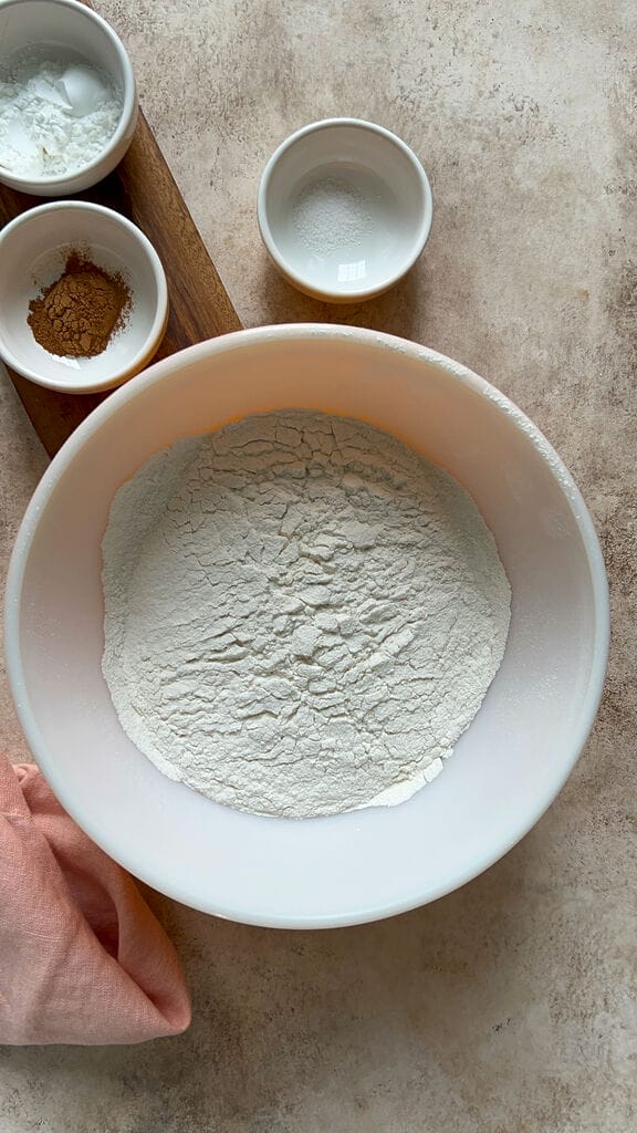 The flour surrounded by cinnamon, salt and bakign powder.