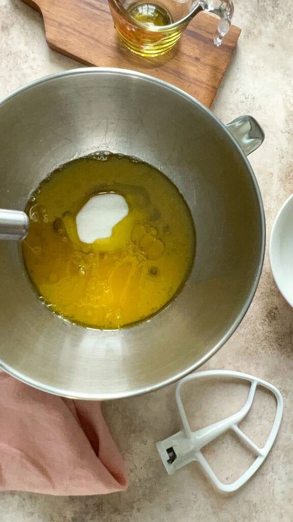 Mixing together the sugar, orange juice and olive oil.