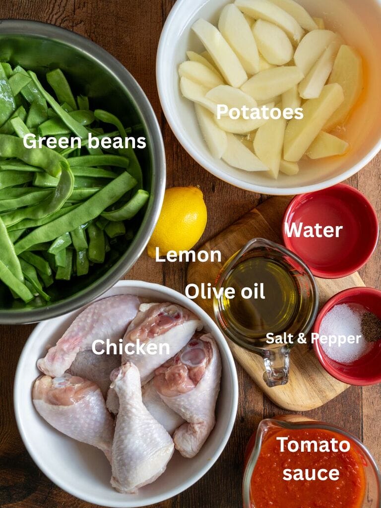 Ingredients for Green beans baked with chicken and potatoes which include: green beans, chicken, potatoes, tomato sauce, lemon, olive oil, water, salt and pepper.