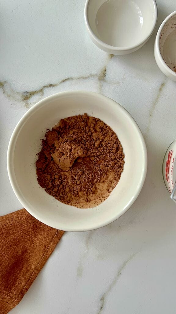 Mixing the cocoa with a small amount of milk.