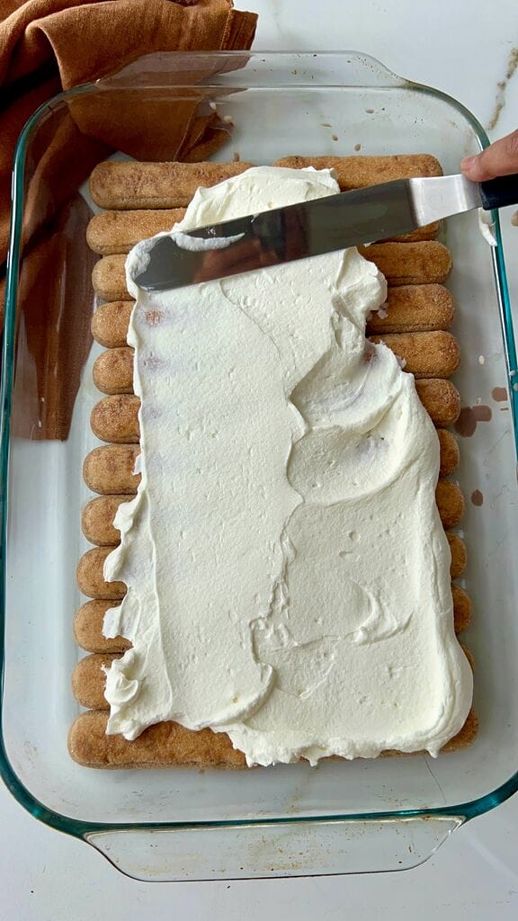 Spreading the whipped cream in a layer.