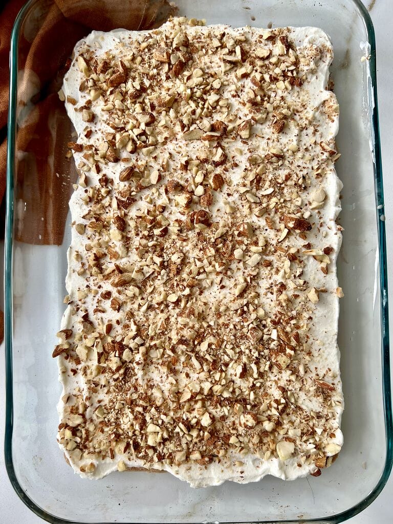 Topping it with almonds.