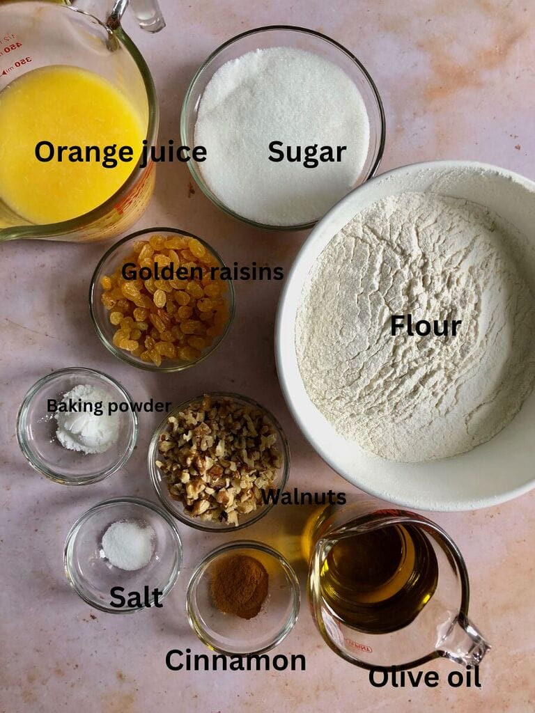 Ingredients needed for: Phanouropita or Fanouropita which include: Flour, orange juice, sugar, golden raisins, walnuts, baking powder, salt, cinnamon and olive oil.