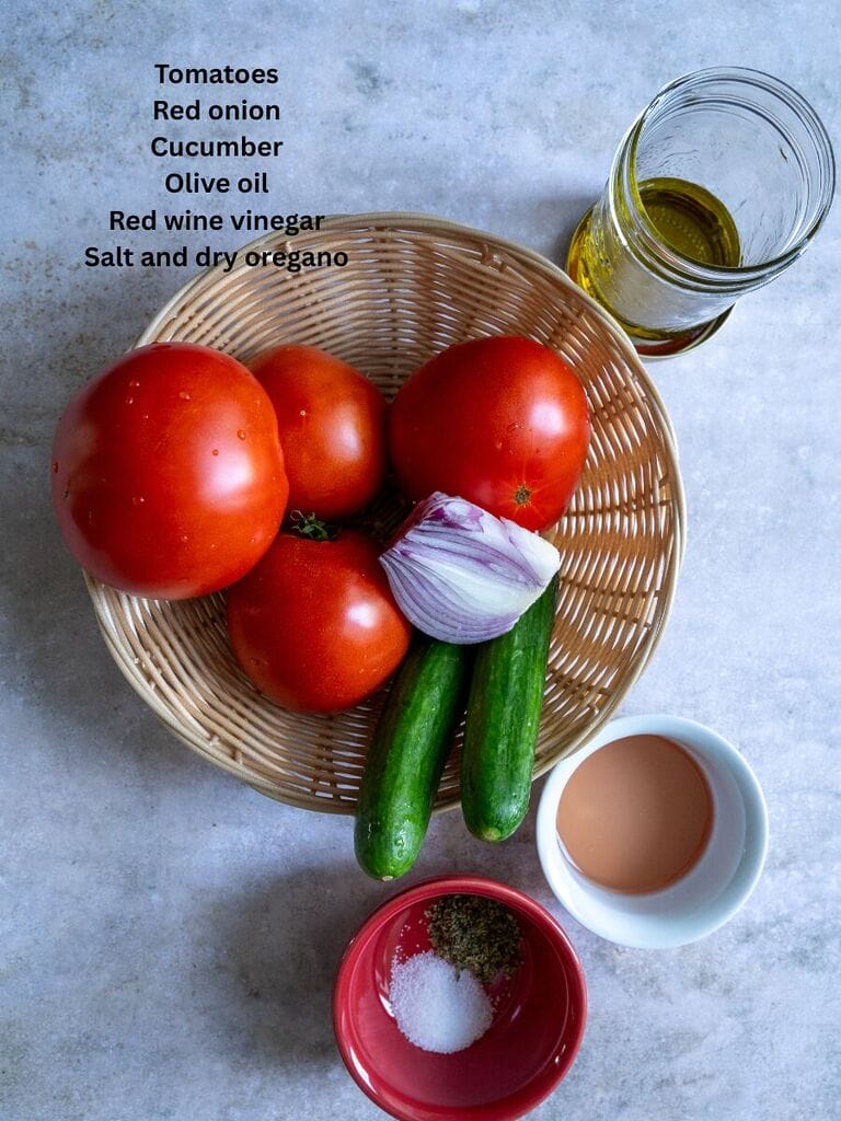 Ingredients for the Tomato and cucumber salad which include: Tomatoes, Red onion, Cucumbers, olive oil, red wine vinegar, salt and dry oregano.