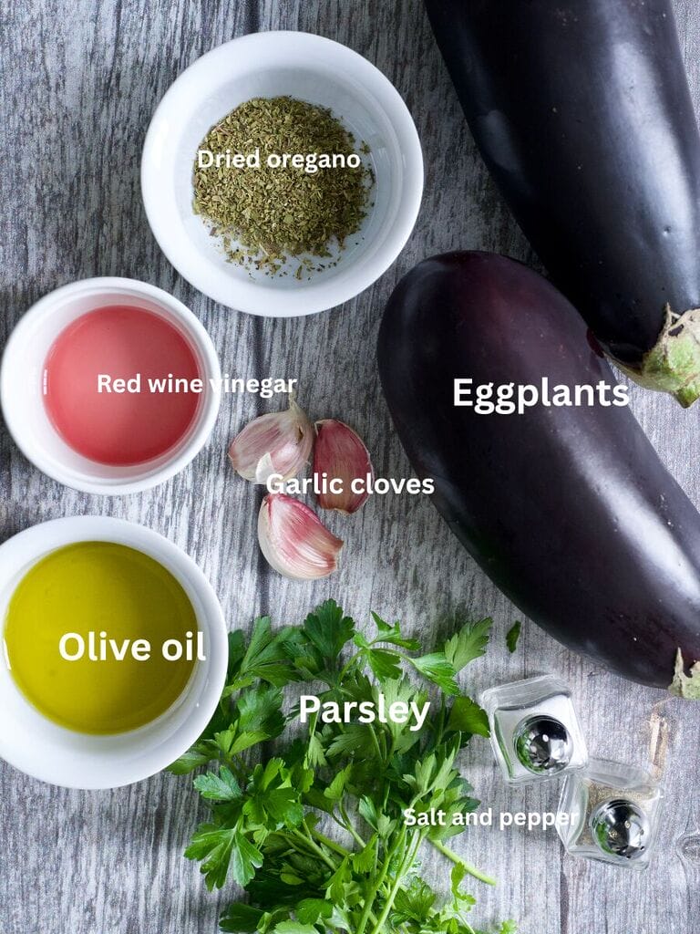 Ingredients for Greek eggplant dip which include: Eggplants, olive oil, red wine vinegar, garlic cloves, olive oil , parsley and salt and pepper.