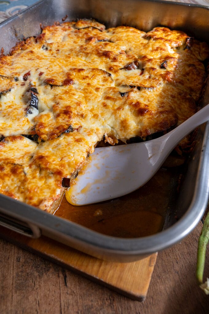 Eggplant, potato and mozzarella baked casserole in a stainless steel casserole dish.