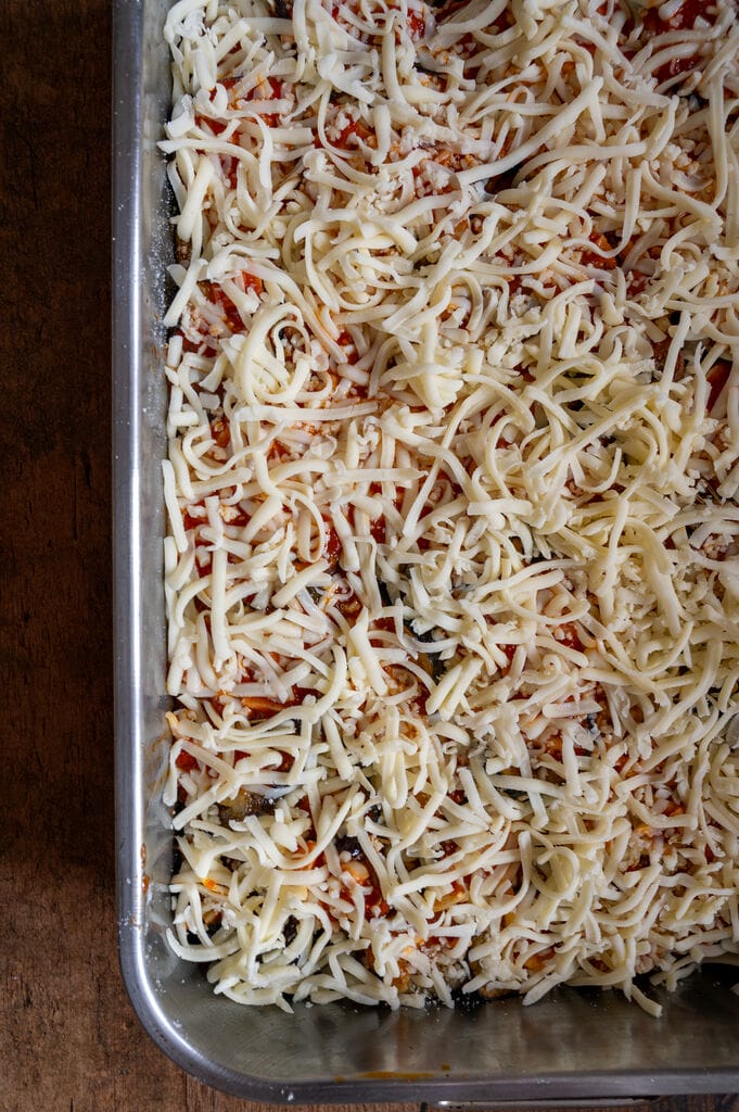 Eggplant, potato and mozzarella baked casserole in a stainless steel casserole dish.
