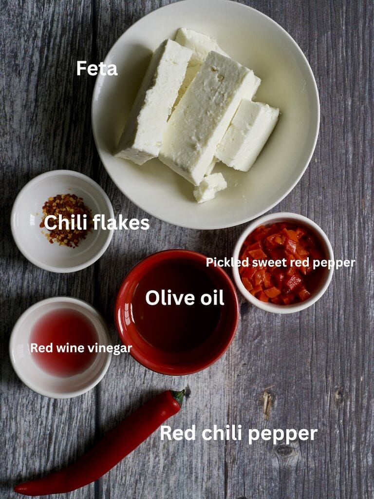 Ingredients which include: Feta, chilli flakes, pickled sweet red pepper, red wine vinegar, olive oil, red chili pepper.