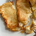 Cutting into a piece of the cheese saganaki.