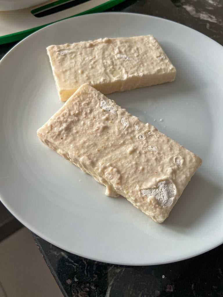 The cheese pieces after they've been dunked into the flour and then the ice water.