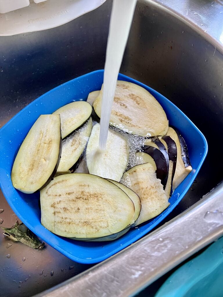 Rinsing the eggplant.