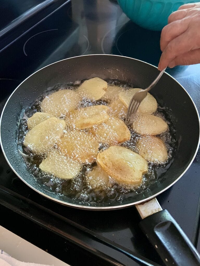 Frying the potatoes.