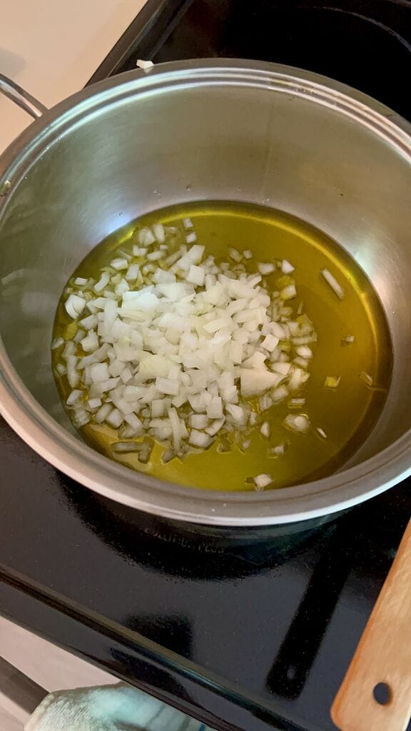 Sautéing the onion in olive oil.
