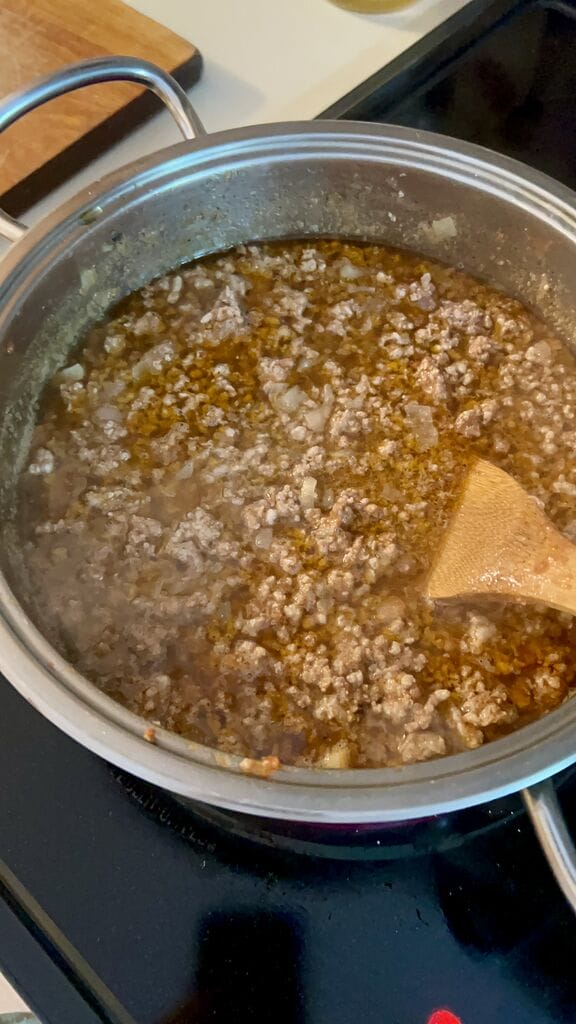 Making the meat sauce.
